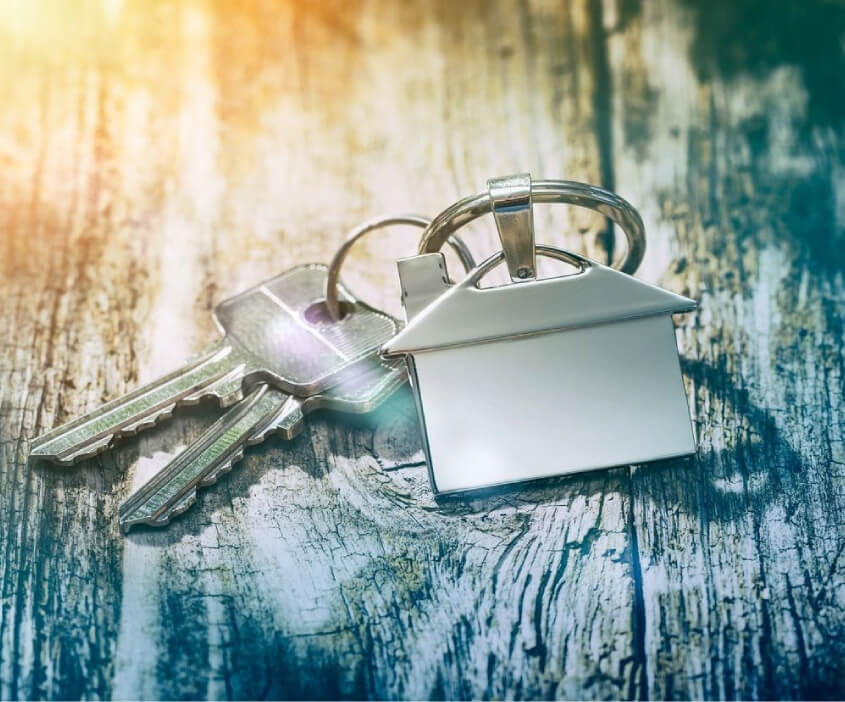 A Home Shaped Keychain With Keys
