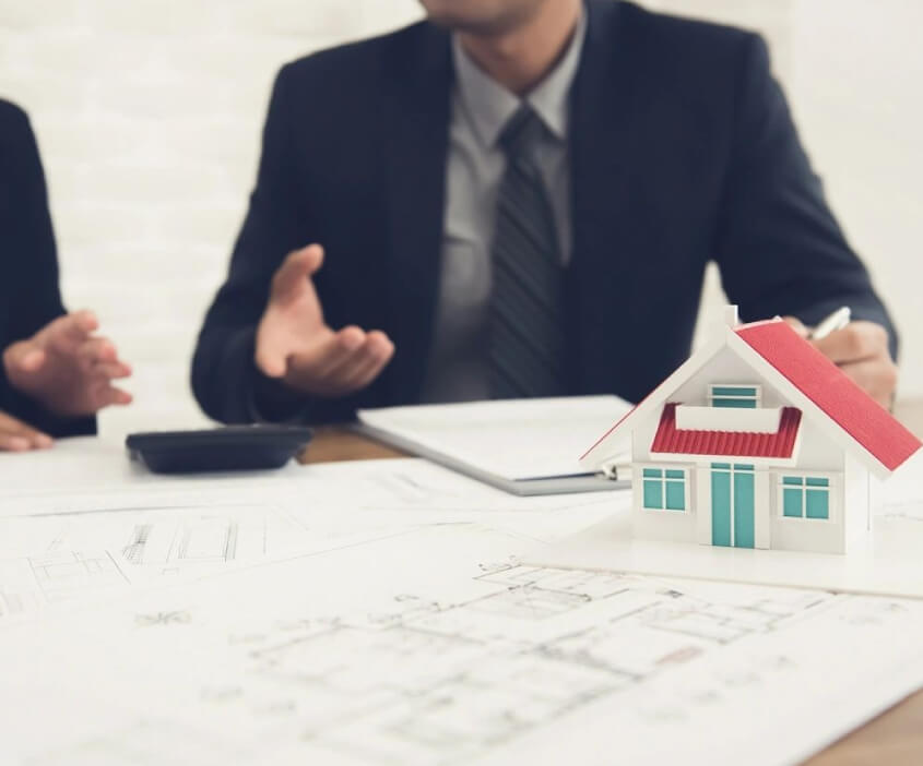 Men Discussing Over a Model Home