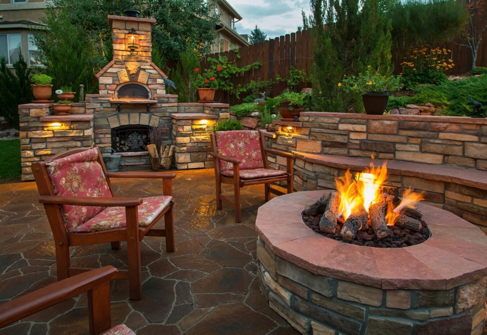 An Outdoor Space With a Fire Pit and Stone Railing