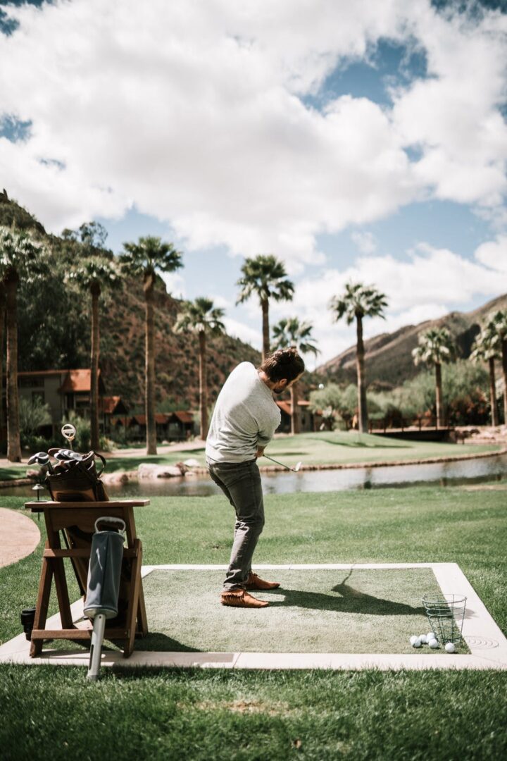 A Man Playing Golf on a Practice Stand