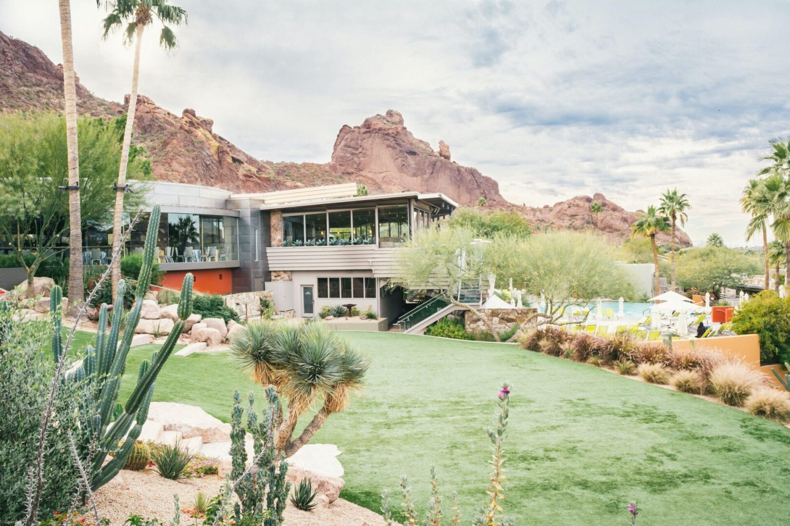 A Home With a Lawn by a Rock Laden Plain